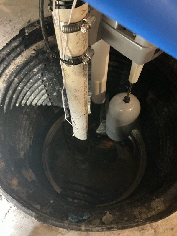 Responded to service call for sump pump system experiencing constant water dripping and excessive noise since January, along with water heater maintenance request. Upon inspection, evaluated sump pump basin installation with primary pump unit, float switch assembly, and backup water system. Identified potential issues related to elevated water table or system leak causing continuous water infiltration. Examined discharge piping, electrical connections, and float mechanism operation. Assessed black corrugated drainage pipes entering basin and verified pump cycling functionality. Performed diagnostic evaluation of water heater tank and completed flush procedure to remove sediment buildup and ensure optimal performance. Documented system configuration including PVC discharge lines, backup pump assembly, and electrical components. Provided recommendations for addressing constant water dripping issue and noise concerns.