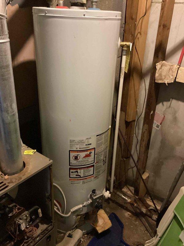 Conducted on-site assessment for furnace replacement estimate in utility room. Current natural gas furnace is non-operational with unknown age and requires full replacement. Evaluated existing installation location, electrical service panel with adequate circuit capacity, and surrounding infrastructure including water heater and HVAC equipment to determine proper sizing and installation requirements for new gas furnace system.