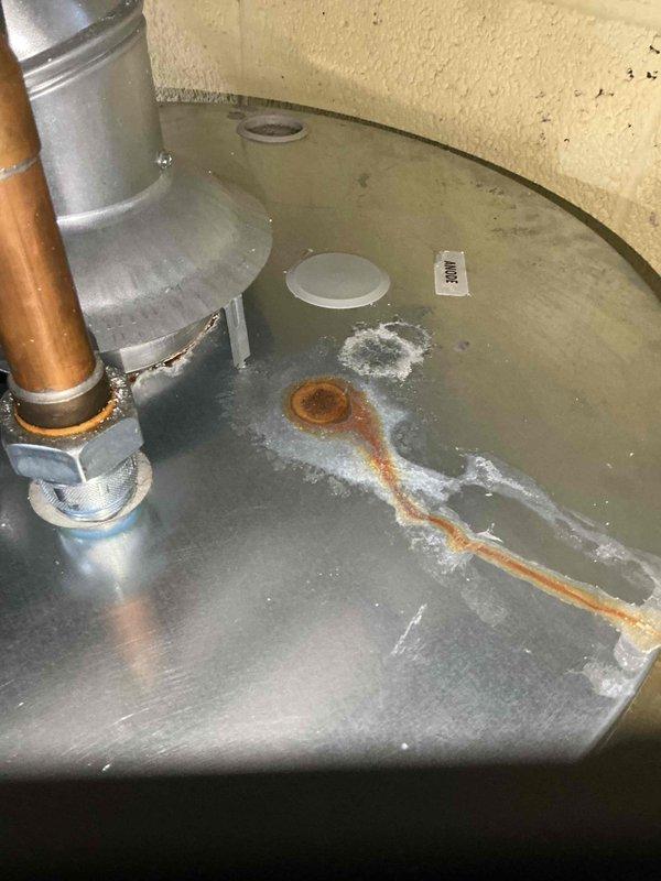 Responded to a water leak complaint on a furnace system under 10 years old located in the basement. Upon inspection, identified active water accumulation in the drain pan and corrosion on metal components, with moisture present around copper piping connections to the furnace. Assessed the condensate drainage system and associated plumbing connections, documented conditions with photographic evidence, and addressed the leak source under warranty coverage.