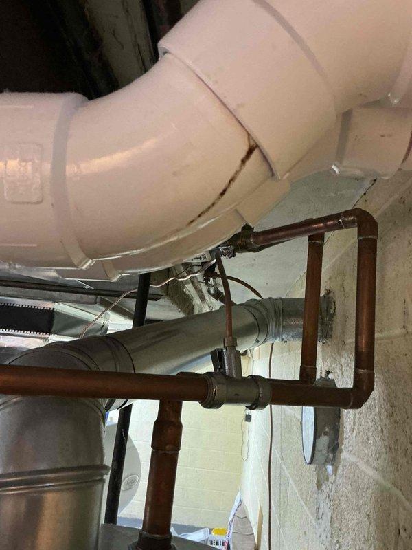 Responded to a water leak complaint on a furnace system under 10 years old located in the basement. Upon inspection, identified active water accumulation in the drain pan and corrosion on metal components, with moisture present around copper piping connections to the furnace. Assessed the condensate drainage system and associated plumbing connections, documented conditions with photographic evidence, and addressed the leak source under warranty coverage.