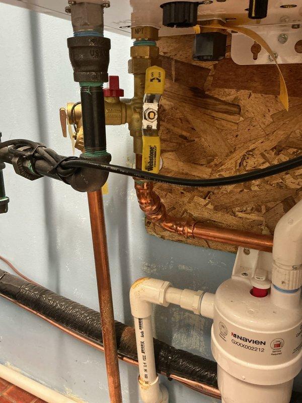 Responded to tankless water heater service call following HVAC technician assessment. Replaced three-quarter inch copper piping components including pro press 90-degree fitting, 45-degree fitting, and coupling with approximately 12 inches of new three-quarter inch pipe. Installed new tankless water heater isolation valves to ensure proper system operation and maintenance access. Brought tankless flush kit on-site and offered descaling service to homeowner. Upon inspection, verified water quality conditions were favorable with minimal scale buildup observed on related equipment. Tested all connections for leaks, confirmed proper valve operation, and verified system functionality upon completion.