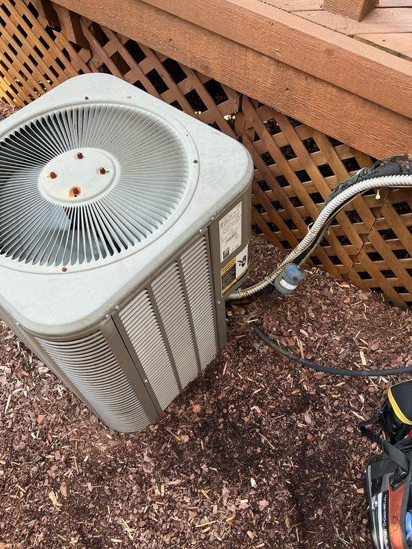Completed Gold AC inspection on non-operational residential air conditioning system over 10 years old with air handler located in basement. Performed comprehensive diagnostic testing using digital multimeter, measuring electrical parameters at condensing unit including voltage readings of 333.0V, and inspected all wiring connections and control circuits. Evaluated outdoor condensing unit condition, airflow components, and overall system performance to identify cause of equipment failure.
