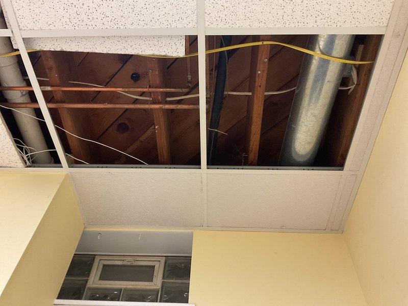 Conducted a no-charge second opinion site visit to reassess and modify original plumbing estimate. Evaluated existing piping configuration in basement area including brass T-junction valve assembly with compression fittings, black flexible tubing connections, and PVC components installed among exposed floor joists. Documented current conditions and reviewed additional copper piping, ductwork, and utility routing in ceiling space to provide revised estimate incorporating requested modifications to original scope of work.