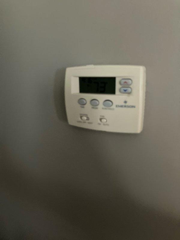 Conducted estimate for air conditioning system replacement at residential property. Existing 30-year-old outdoor condensing unit located on concrete pad in backyard has reached end of serviceable life. Assessed current installation including exterior unit placement, electrical service connections, and existing Emerson thermostat. Documented equipment condition and provided replacement system options for aging AC unit.