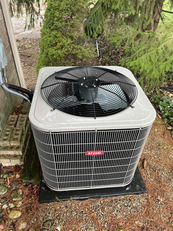 Completed comprehensive Gold AC inspection on 10-year-old single-zone residential air conditioning system with air handler located in basement. Performed thorough evaluation of outdoor condenser unit positioned on gravel pad in side yard, confirming proper operation and clearance from surrounding landscaping and debris. Inspected control board components including DIP switches, capacitors, terminal connections, and integrated circuits to verify proper electrical function and system settings.