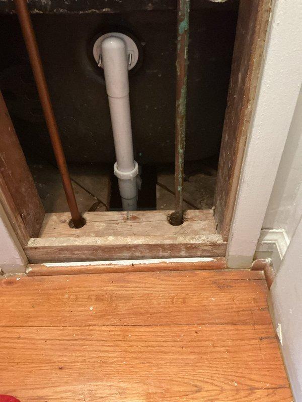 Removed leaking brass trip waste and drum trap assembly from bathtub and replaced with new PVC trip waste and P-trap configuration. Work required access through basement ceiling to remove deteriorated drainage components and install updated plumbing system to eliminate active leak. All connections tested and verified operational with one-year labor warranty provided.