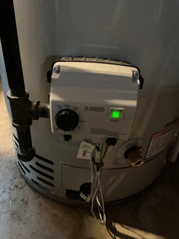 Responded to service call for buzzing noise originating from Bradford White Defender Safety System water heater installed in 2023. Upon inspection, verified water heater operation, examined Honeywell gas control valve, checked all plumbing connections, copper piping, and exhaust venting system for proper installation and secure mounting. Unit found operating within normal parameters with no active water leaks detected at time of service.