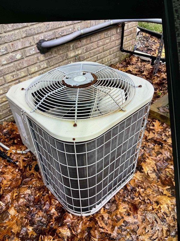Completed comprehensive Gold AC inspection on a 17-year-old Bryant two-unit residential cooling system with basement-located air handler. Performed full system evaluation including condenser unit examination, operational testing, and visual assessment of outdoor equipment condition. Noted significant leaf debris accumulation around condenser base and weathering on unit housing with visible rust spots on top panel. Documented equipment status with photographic evidence showing operational condenser with intact protective grilles and fan guard assembly. System confirmed operational at time of inspection with both units functioning as designed.