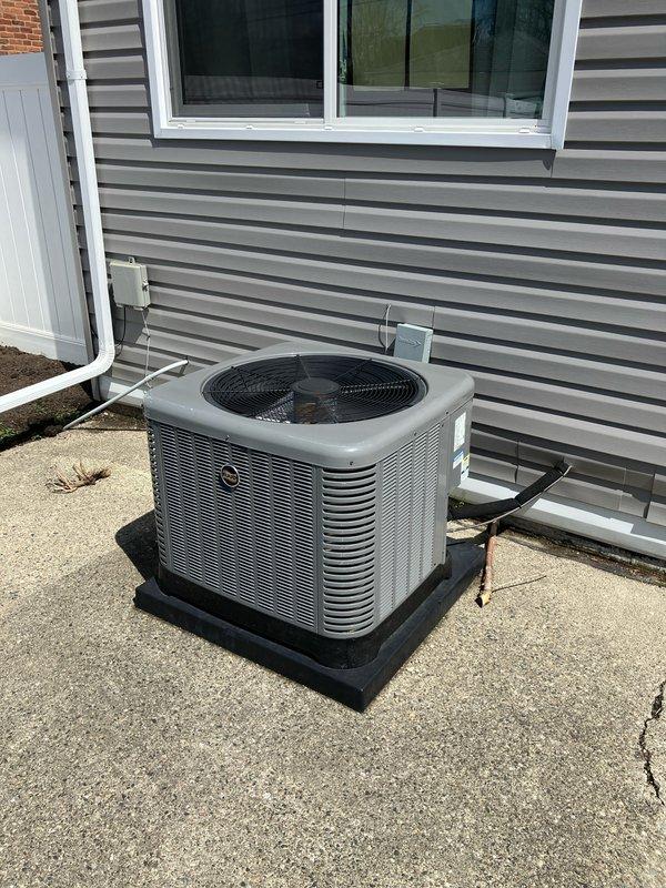 Conducted comprehensive on-site evaluation for complete HVAC system replacement including 2-ton furnace, air conditioning unit, and hot water heater. Inspected existing outdoor condenser unit mounted on concrete pad with vibration dampening base, assessed refrigerant line penetrations through exterior wall, and verified electrical disconnect box configuration. Documented current system specifications and photographed equipment condition for replacement estimate preparation. Evaluated utility service connections including electric and gas meter locations to determine installation requirements for new equipment. Provided customer with detailed replacement options and system specifications for complete system upgrade.