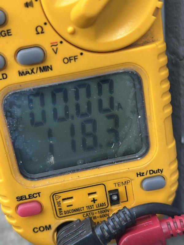 Completed comprehensive annual maintenance on 15-year-old air conditioning unit located outside garage. Performed full system diagnostics using digital multimeter to verify electrical performance, measuring voltage and amperage readings to ensure proper operation of all components. All electrical parameters tested within manufacturer specifications, confirming system functionality and safe operation for continued use.
