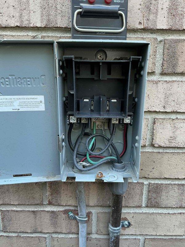 Performed preventative maintenance tune-up on a 5-year-old residential air conditioning system. Inspected outdoor condenser unit mounted on elevated plastic grid platform with proper drainage, verified unit operational integrity and fan guard security. Examined electrical disconnect box and service panel mounted on exterior wall, confirmed all wire connections, terminals, and conductors properly secured with appropriate color coding. Inspected evaporator coil located in basement area. System operating within normal parameters with no deficiencies noted at time of service.