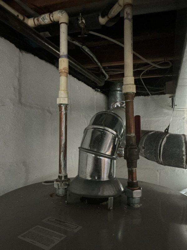 Completed warranty installation of a 50-gallon standard tanked water heater in basement utility area. Replaced existing unit, connected supply and discharge piping to new tank, verified proper venting configuration, and tested all connections for leaks. Unit operational and functioning within manufacturer specifications upon completion.
