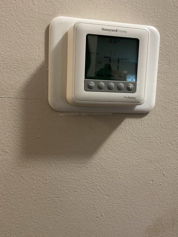 Completed comprehensive Gold AC Inspection on a 2-year-old multi-unit HVAC system with air handler located in basement. Verified Honeywell Home ProSeries thermostat operation and settings, inspected basement-mounted equipment including air handler and associated ductwork connections, and confirmed all system components were functioning properly with no service issues identified at time of inspection.