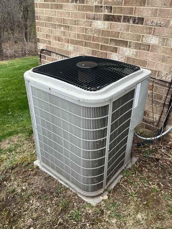 Completed Gold plan cooling maintenance on a 2-year-old Bryant air conditioning system with outdoor condenser unit installed on concrete pad against exterior wall. Performed comprehensive AC tune-up including inspection of condenser coils, refrigerant lines, electrical connections, and overall system operation. Unit found in good working condition with no issues identified; all components functioning properly and system ready for cooling season.