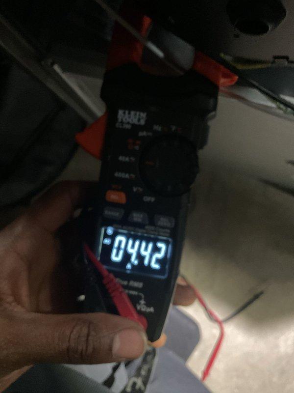 Completed AC system startup on basement evaporator coil installation. Performed electrical diagnostics and measurements using digital multimeter, confirming proper amperage draw of 4.42 amps on blower motor assembly. Verified all copper line connections at coil were secure and properly brazed. System tested and operating within manufacturer specifications.