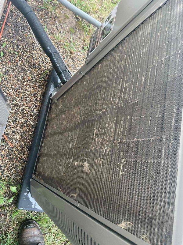 Completed comprehensive spring AC tune-up on 2023 outdoor condensing unit as part of prepaid maintenance plan. Inspected and cleaned heat exchanger coils which showed moderate accumulation of environmental debris and dirt between aluminum fins; performed thorough exterior cabinet cleaning to remove weathering and surface contamination. Verified refrigerant line connections, tested electrical components including fan motor operation, and confirmed system operational readiness for cooling season.