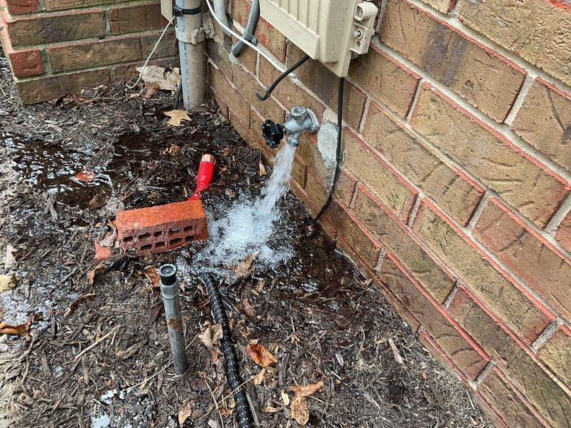 Responded to a recurring water leak at an outdoor spigot where a previously repaired 3-foot section of supply pipe had failed again. Upon arrival, confirmed active water discharge from cracked pipe near the hose bib, with water infiltrating the interior wall cavity adjacent to the exterior spigot location. Shut off water supply and removed the failed pipe section. Installed new PVC supply line to replace the compromised section, ensuring proper fitting connections and secure mounting. Applied spray foam insulation around the penetration point through the brick wall to seal the opening and prevent future moisture intrusion into the interior space. Tested the outdoor spigot under full pressure to verify proper operation and confirmed no leaks at connections or along the newly installed pipe run.