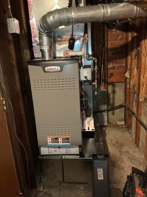 Completed comprehensive Gold AC Inspection and tune-up on a 1.5-year-old Lennox heating and cooling system located in the lower level utility room. Performed full system diagnostics, cleaned condenser coils, checked refrigerant levels and pressures, inspected electrical connections, tested thermostat operation, verified proper airflow through ductwork, and replaced air filter. System operating within manufacturer specifications with no issues identified; all components functioning properly and ready for continued service under maintenance plan.