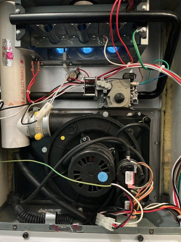 Performed comprehensive tune-up on residential HVAC system including 3-year-old outdoor condensing unit and 12-year-old gas furnace located in basement. Inspected condensing unit positioned in side yard on concrete pad, verified proper airflow through top-mounted fan assembly and side louvers, checked electrical connections and refrigerant levels. Accessed furnace interior components, inspected blower motor assembly, examined gas valve connections and burner assembly, verified all electrical wiring and control board connections secure, tested safety switches and capacitors. All systems operating within normal parameters with no issues identified during routine maintenance inspection.