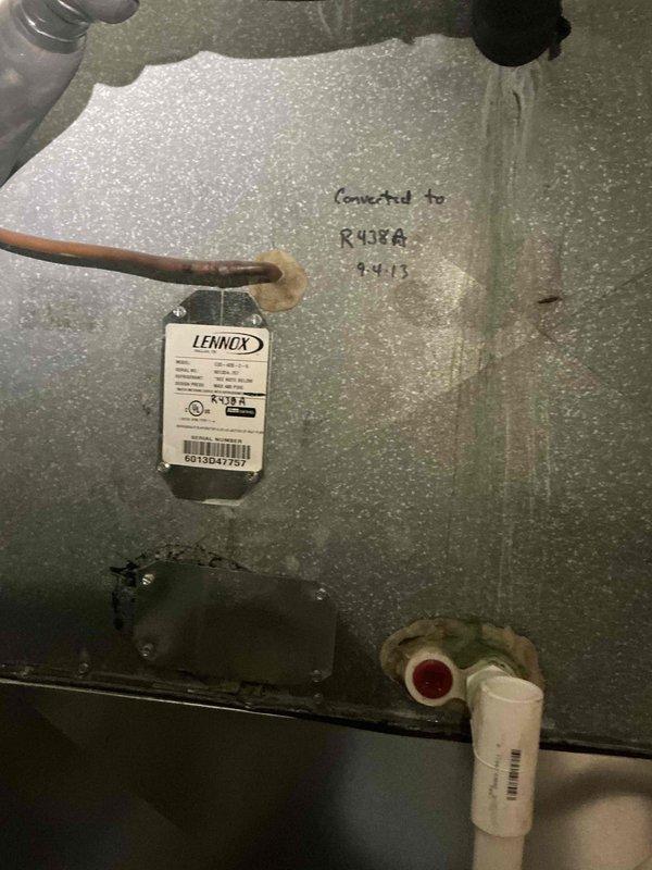 Completed comprehensive Gold AC inspection on a two-unit residential HVAC system with equipment under 10 years old. Inspected Lennox air handler located in basement, verifying proper refrigerant line connections, condensate drain operation with trap and PVC discharge lines, and overall system integrity within insulated enclosure. Examined outdoor condenser unit, confirming fan assembly operation, evaluating exterior condition showing normal weathering, and noting operational status of all components with both systems functioning properly at time of inspection.