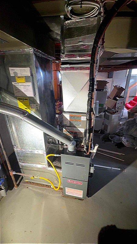 Completed full HVAC system installation including new Lennox outdoor condenser unit and indoor evaporator coil for rental property. Installed condenser on rubber pad against exterior brick wall with proper PVC condensate drainage and electrical connections. Indoor coil integrated with existing furnace system in basement with new refrigerant lines, ductwork connections, and gas line configuration. All components tested for proper operation, refrigerant charge verified, and system commissioned successfully. Permit obtained and installation completed per customer specifications.