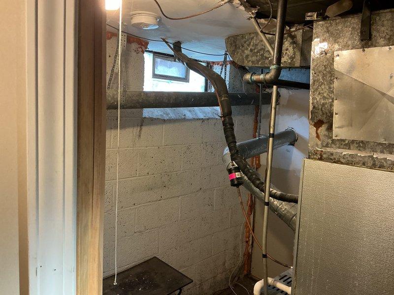 Installed a 40-gallon A.O. Smith tanked water heater in basement utility area with copper supply connections and proper venting configuration. Unit was positioned on concrete floor with all safety labels visible and accessible, red valve handles installed on water lines, and chimney liner assessment completed to ensure proper exhaust ventilation. All plumbing connections were secured and tested for leaks, with installation meeting local code requirements for residential water heating systems.