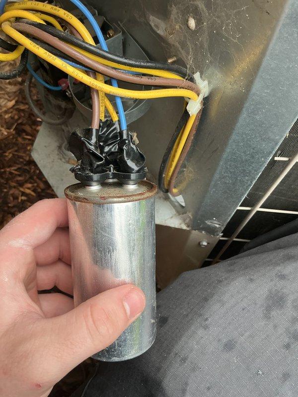 Responded to service call for central air conditioning system experiencing reduced cooling efficiency. Upon inspection, identified failed dual-run capacitor showing visible signs of deterioration, oxidation, and discoloration. Replaced defective capacitor with new unit, reconnected all electrical terminals per manufacturer specifications, and verified proper system operation. Unit now cooling effectively with normal compressor and fan motor operation restored.