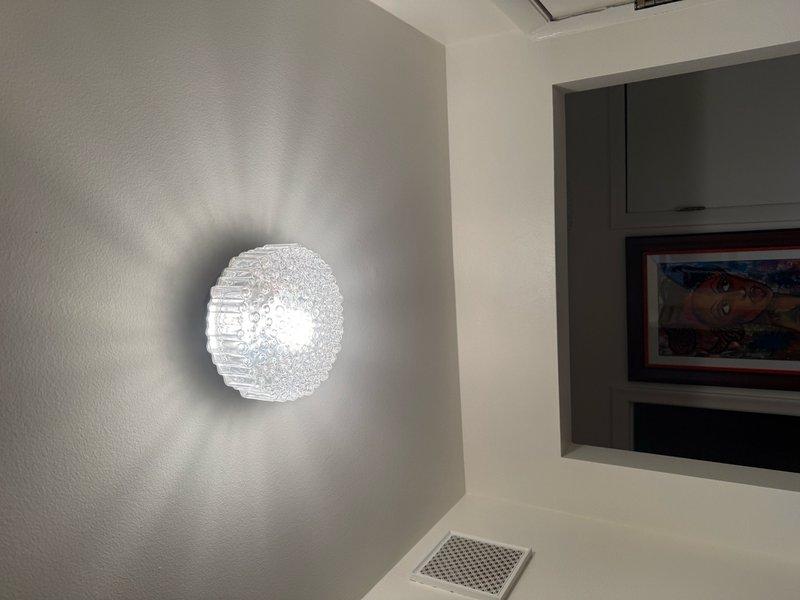 Responded to service call for hallway light fixture that was inoperative following recent furnace installation. Investigated electrical circuit and determined that wiring had been inadvertently disconnected during HVAC work. Restored proper electrical connections to wall-mounted decorative light fixture, verified operation, and confirmed all circuits functioning correctly. Fixture now operating as intended with no further issues identified.
