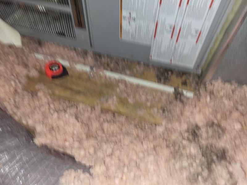 Provided estimate for replacement of 24-year-old second-floor air conditioning system with failed outdoor fan motor and cracked/broken condenser top where motor mounts. Evaporator coil located in attic with extremely tight access constraints documented through photos showing limited workspace and existing ductwork configuration. Property contains two AC units total; assessed second unit with seized fan motor and confirmed operational status of remaining system components per customer request.