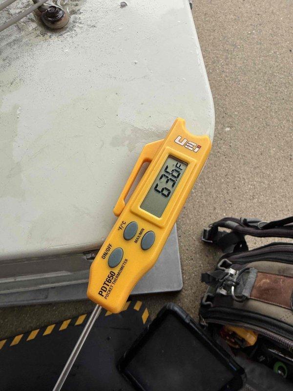 Completed comprehensive Gold AC inspection on 25-year-old residential air conditioning system with air handler located in basement. Performed temperature diagnostics on outdoor condenser unit, recording operating temperatures using digital thermometer. Inspected evaporator coil and identified visible staining on coil surface indicating potential condensate or moisture-related issues. System currently operational with all components functioning at time of inspection.