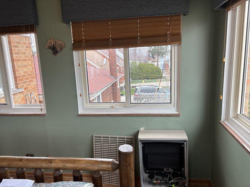 Completed wall furnace installation and reconnection in residential space. Mechanical and electrical permits were requested and processed for the wall-mounted heating unit. Unit was installed below window in room with light green walls, with white ventilation grille properly mounted and appliance positioned for optimal heating distribution. All connections verified and system checked for proper operation upon completion.