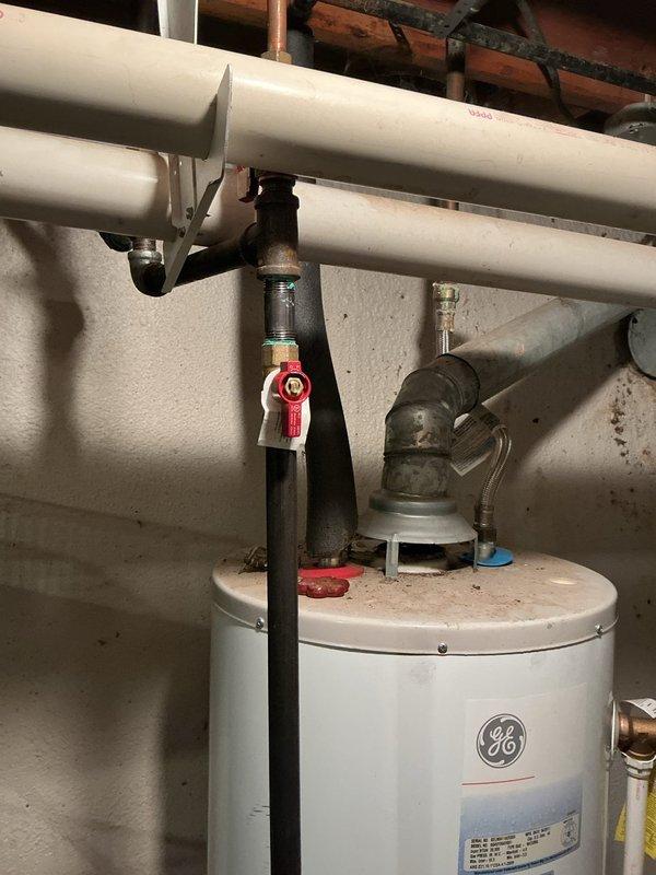 Completed gas line installation and routing work in accordance with approved estimate. Installed new gas piping from water heater location through basement mechanical room, running lines along floor joists to designated endpoint. Routed copper and black iron pipe through underside of deck structure, securing all lines with appropriate fasteners and supports to wooden beams. Installed shutoff valve on vertical gas line connected to water heater for safety and code compliance. All gas line work performed to local building codes and manufacturer specifications, with proper pipe sizing and fitting connections. System tested and verified operational upon completion.