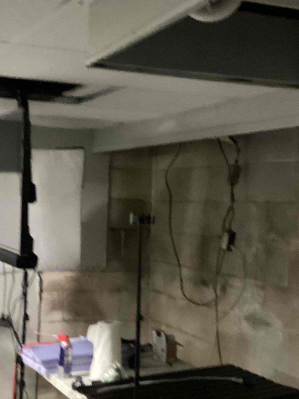 Conducted comprehensive site assessment for HVAC system replacement at residential property. Documented existing exterior electrical infrastructure including meter box, junction panels, and conduit routing on brick exterior wall to ensure proper coordination with new HVAC equipment installation. Evaluated interior basement area conditions, noting unfinished walls with moisture concerns and existing utility routing that will require consideration during equipment placement and ductwork installation.