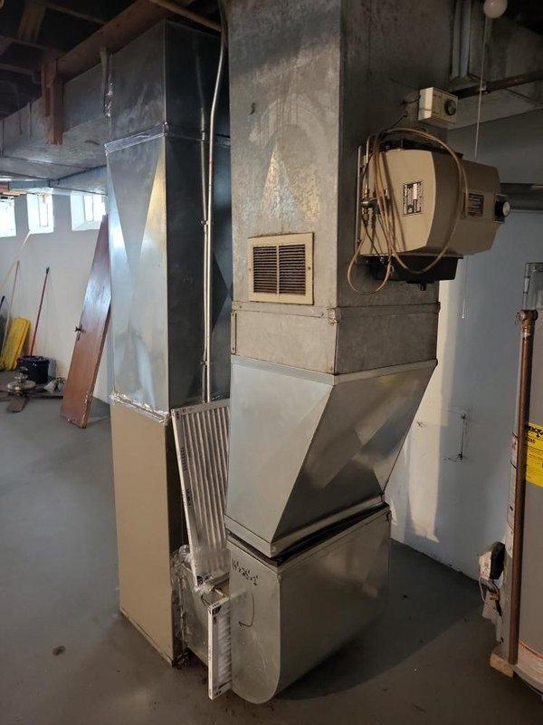 Conducted site assessment for air conditioning unit installation in basement mechanical room where previous unit had been removed. Evaluated existing HVAC infrastructure including furnace, humidifier, ductwork connections, and available space for new AC equipment. Documented current system configuration and prepared installation estimate for replacement air conditioning unit.