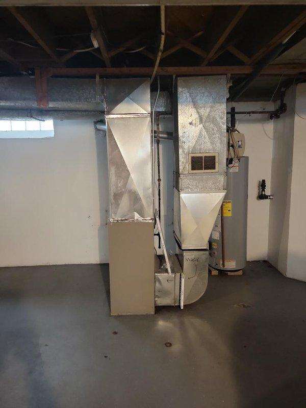 Conducted site assessment for air conditioning unit installation in basement mechanical room where previous unit had been removed. Evaluated existing HVAC infrastructure including furnace, humidifier, ductwork connections, and available space for new AC equipment. Documented current system configuration and prepared installation estimate for replacement air conditioning unit.