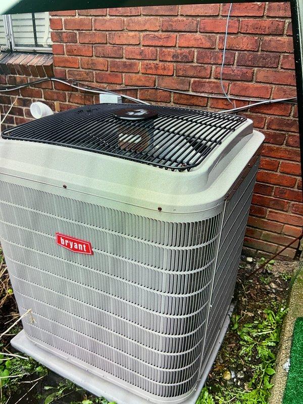 Completed comprehensive Gold AC inspection on 10+ year old Bryant air conditioning system with air handler located in basement. Performed full system evaluation including outdoor condenser unit examination, verified proper equipment operation, and documented unit condition through photographic records. System found to be functioning properly at time of inspection with condenser unit showing normal weathering consistent with age, protective grilles intact, and all components operational.