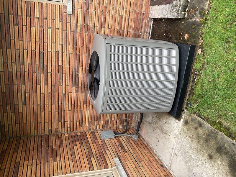 Completed installation of 5-ton air conditioning system with new evaporator coil, including Lennox air handler unit positioned in basement utility area and outdoor condenser unit mounted on pad at rear of property. Installed proper condensate drainage system with PVC piping, reconnected all electrical and mechanical connections, and obtained required mechanical, electrical, and AC permits. System tested and verified operational upon completion.