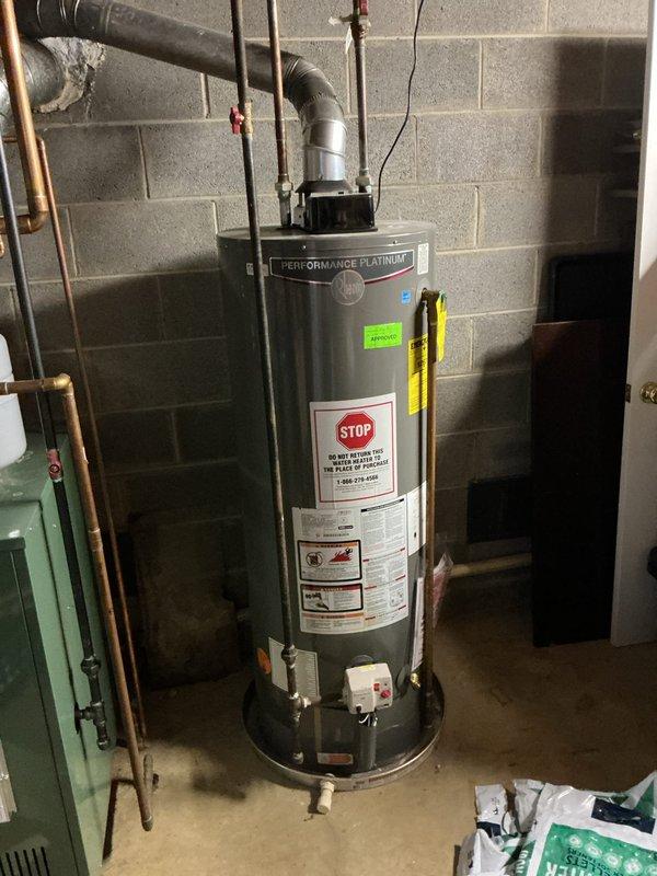 Responded to complaint of rotten egg smell from hot water throughout residence, ongoing for 2-3 weeks. Inspected 50-gallon natural gas Performance Platinum water heater (Model M50T12DM40U0, manufactured September 2019, 40,000 BTU input) located in basement. Identified hydrogen sulfide odor characteristic of sulfate-reducing bacteria growth within tank, common in units with magnesium anode rods and homes with well water or low chlorine levels. Recommended and performed anode rod replacement with aluminum/zinc alloy rod to eliminate bacterial growth and prevent future odor issues. Flushed tank to remove sediment and bacterial buildup. Verified proper venting, gas pressure, and operational safety of unit. Tested hot water at multiple fixtures throughout home to confirm odor elimination. Unit operating within manufacturer specifications with no safety concerns noted.