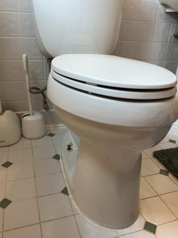 Responded to water leak complaint at customer-supplied toilet installation approximately six years old. Upon inspection, confirmed active water leak originating from toilet fixture resulting in visible mold growth in surrounding bathroom area. Documented conditions through photography showing toilet installation, bathroom fixtures, and affected ceiling cavity with exposed structural elements and moisture damage. Leak source traced to toilet assembly with water infiltration causing deterioration of adjacent building materials. Assessed extent of water damage including ceiling discoloration and compromised substrate requiring remediation. Verified leak was related to original toilet installation and documented findings for warranty determination and further action recommendations.