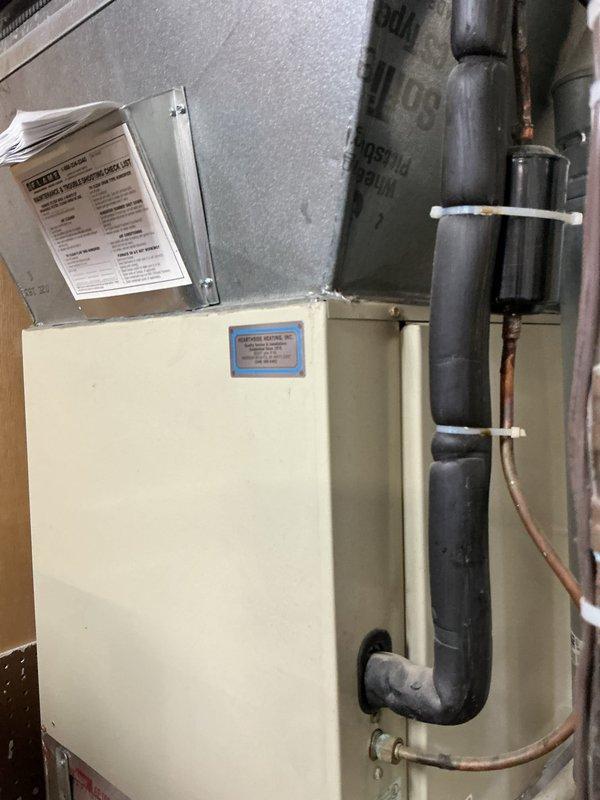 Responded to no cooling complaint for 20-year-old rooftop AC unit serving one side of commercial building. Upon arrival, found system completely off and non-operational. Performed diagnostic inspection of outdoor condensing unit and indoor air handler components. Documented equipment condition including 13ACX model condenser with specification plate, heat exchanger coils, wire guard protection, refrigerant line connections, and associated mechanical room components. Captured photographic documentation of unit installation, refrigerant piping with insulation, and equipment nameplate data for service records.