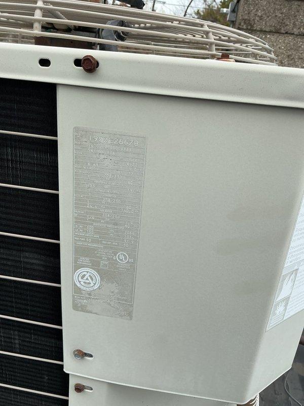 Responded to no cooling complaint for 20-year-old rooftop AC unit serving one side of commercial building. Upon arrival, found system completely off and non-operational. Performed diagnostic inspection of outdoor condensing unit and indoor air handler components. Documented equipment condition including 13ACX model condenser with specification plate, heat exchanger coils, wire guard protection, refrigerant line connections, and associated mechanical room components. Captured photographic documentation of unit installation, refrigerant piping with insulation, and equipment nameplate data for service records.