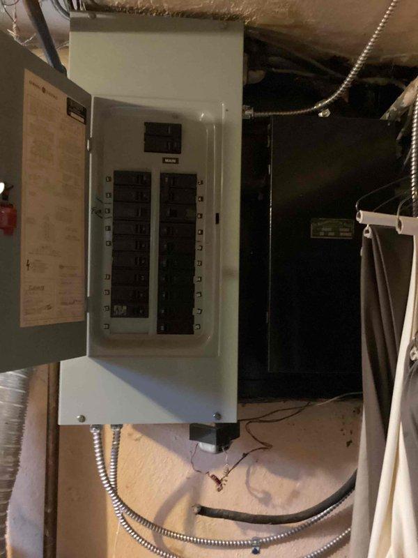 Completed comprehensive Gold AC inspection on a single-unit residential HVAC system with equipment exceeding 10 years of age. Evaluated operational air handler/coil unit located in basement mechanical room, documented existing furnace installation with visible duct repairs and sealing work, and assessed electrical panel connections and service capacity. Equipment was confirmed operational at time of inspection, and photographic documentation was captured for replacement estimate preparation.