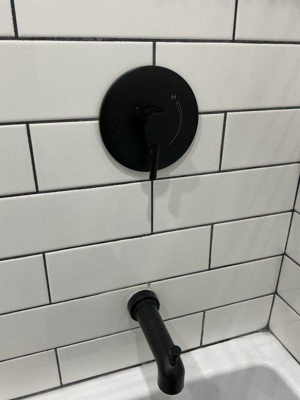 Responded to no hot water complaint following recent home renovation. Investigated plumbing configuration and identified improperly installed water lines preventing hot water delivery to specific areas of the residence. Verified water temperature at fixtures using digital thermometer, confirming hot water supply reaching only 120.8°F at affected bathroom tub/shower location. Documented fixture installation and temperature readings. Explained findings to customer regarding incorrect water line routing from renovation work that requires correction to restore proper hot water distribution throughout the home.