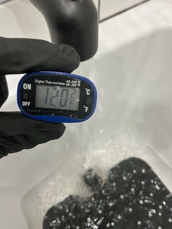 Responded to no hot water complaint following recent home renovation. Investigated plumbing configuration and identified improperly installed water lines preventing hot water delivery to specific areas of the residence. Verified water temperature at fixtures using digital thermometer, confirming hot water supply reaching only 120.8°F at affected bathroom tub/shower location. Documented fixture installation and temperature readings. Explained findings to customer regarding incorrect water line routing from renovation work that requires correction to restore proper hot water distribution throughout the home.