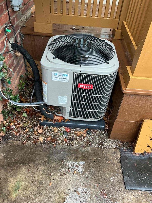 Completed routine preventive maintenance on a five-year-old Bryant air conditioning system located on the exterior east side of the residence. Performed comprehensive tune-up including inspection of condenser unit, refrigerant lines, electrical connections, and fan motor operation. Verified proper system function, cleaned components as needed, and documented unit condition with photographic records showing condenser placement on mounting pad with lattice screening and all associated electrical and refrigerant line connections properly secured to building exterior.