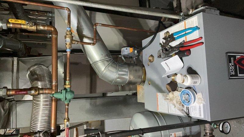 Completed installation of radiator air vent and key valve on hydronic heating system piping. Installed brass automatic air vent fitting with shut-off capability on copper supply line to eliminate trapped air and improve system efficiency. Verified proper operation of all connections and confirmed no leaks at installation points.
