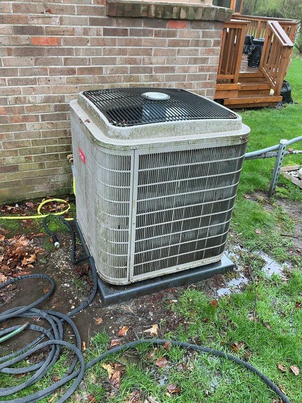 Completed comprehensive Gold-level air conditioning inspection on 10+ year old residential cooling system with basement-located air handler. Outdoor condensing unit showed signs of weathering with visible algae and mildew growth on cabinet surfaces and top panel, indicating need for cleaning and maintenance. Thoroughly evaluated condenser coils, fan operation, refrigerant levels, electrical connections, and overall system performance to ensure optimal cooling efficiency for the upcoming season.