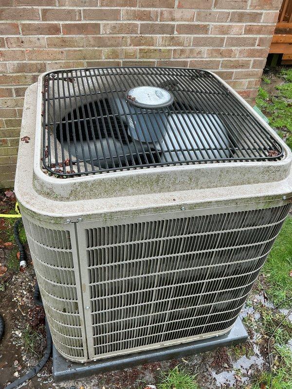 Completed comprehensive Gold-level air conditioning inspection on 10+ year old residential cooling system with basement-located air handler. Outdoor condensing unit showed signs of weathering with visible algae and mildew growth on cabinet surfaces and top panel, indicating need for cleaning and maintenance. Thoroughly evaluated condenser coils, fan operation, refrigerant levels, electrical connections, and overall system performance to ensure optimal cooling efficiency for the upcoming season.