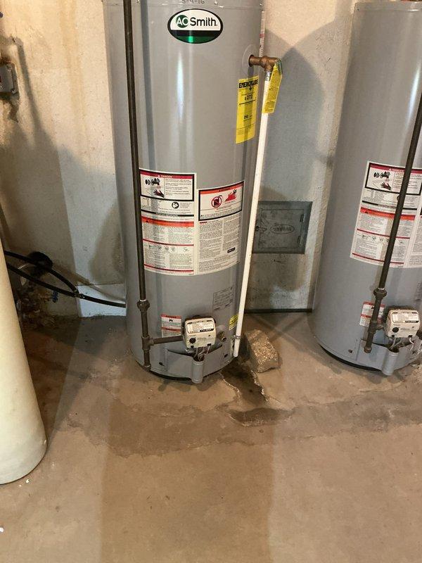 Replaced defective temperature and pressure relief (TPR) valve on A.O. Smith tanked water heater located in basement utility room. Inspected existing copper and PVC plumbing connections, verified proper installation of new brass TPR valve with discharge pipe routing to floor level per code requirements. Tested valve operation, checked for leaks at all connections, and confirmed water heater returned to normal operating parameters with no additional issues identified.