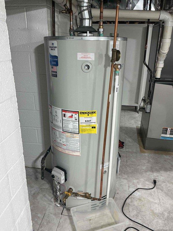 Completed comprehensive Gold AC Inspection on 10-year-old residential HVAC system with air handler/coil located in basement. Performed full system evaluation including visual inspection of all accessible components, ductwork, and mechanical connections. Documented water heater installation per protocol, noting proper copper piping connections, pressure relief valve configuration, gas valve assembly, and drain pan placement. Verified all plumbing connections, flue pipe installation, and safety labels present and legible. Inspected basement mechanical room including HVAC ductwork, electrical wiring, and overall equipment layout for proper installation and clearances.